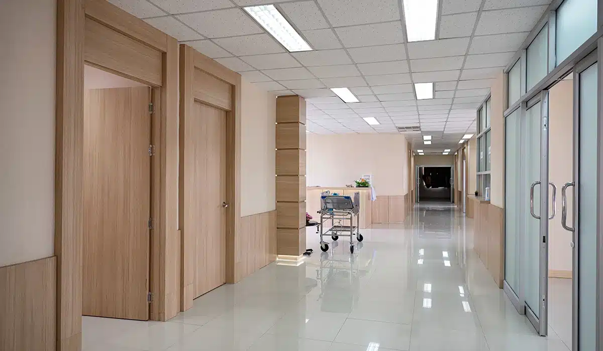 Empty hospital corridor with various rooms and trolley patient service